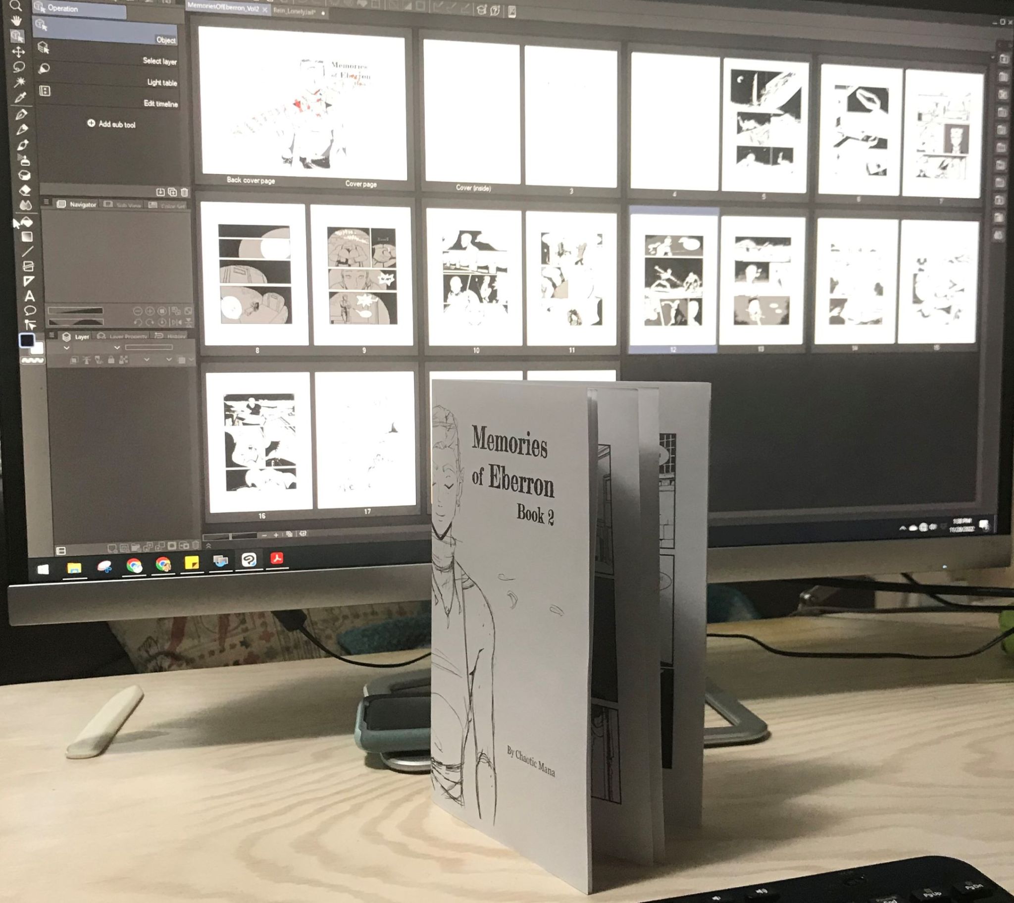 photo of my computer screen with pages from the inside of the book open on Clip Studio Paint.